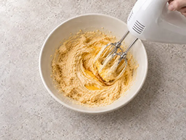 Step 2: Beat the egg and vanilla into the butter mixture.