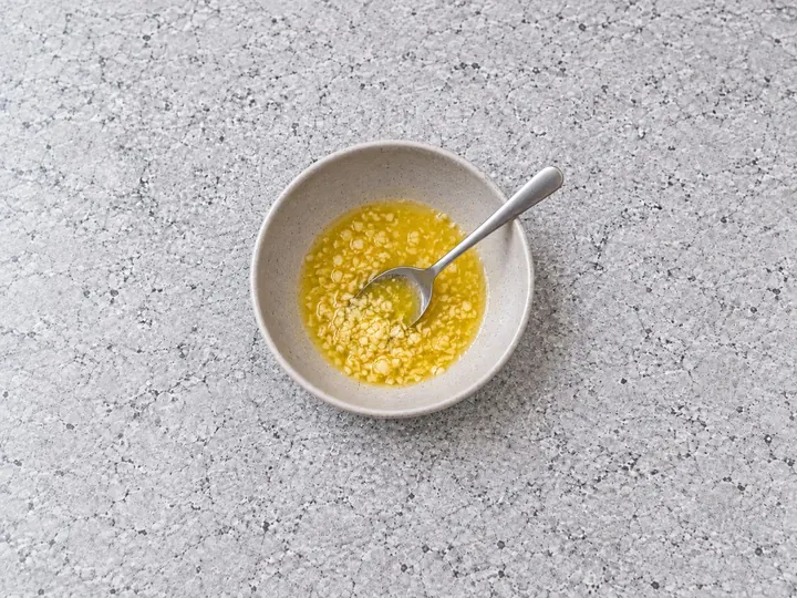 Step 2: Mix the melted butter and minced garlic in a large bowl.