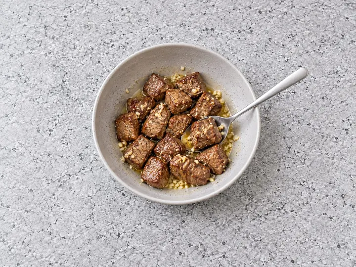 Step 6: Toss the steak bites in the garlic butter and put them back in the basket.